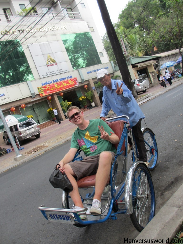 Catching a cyclo in Ho Chi Minh City, Vietnam.